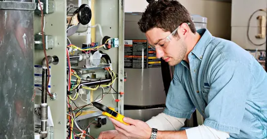 Service technician testing a furnace.